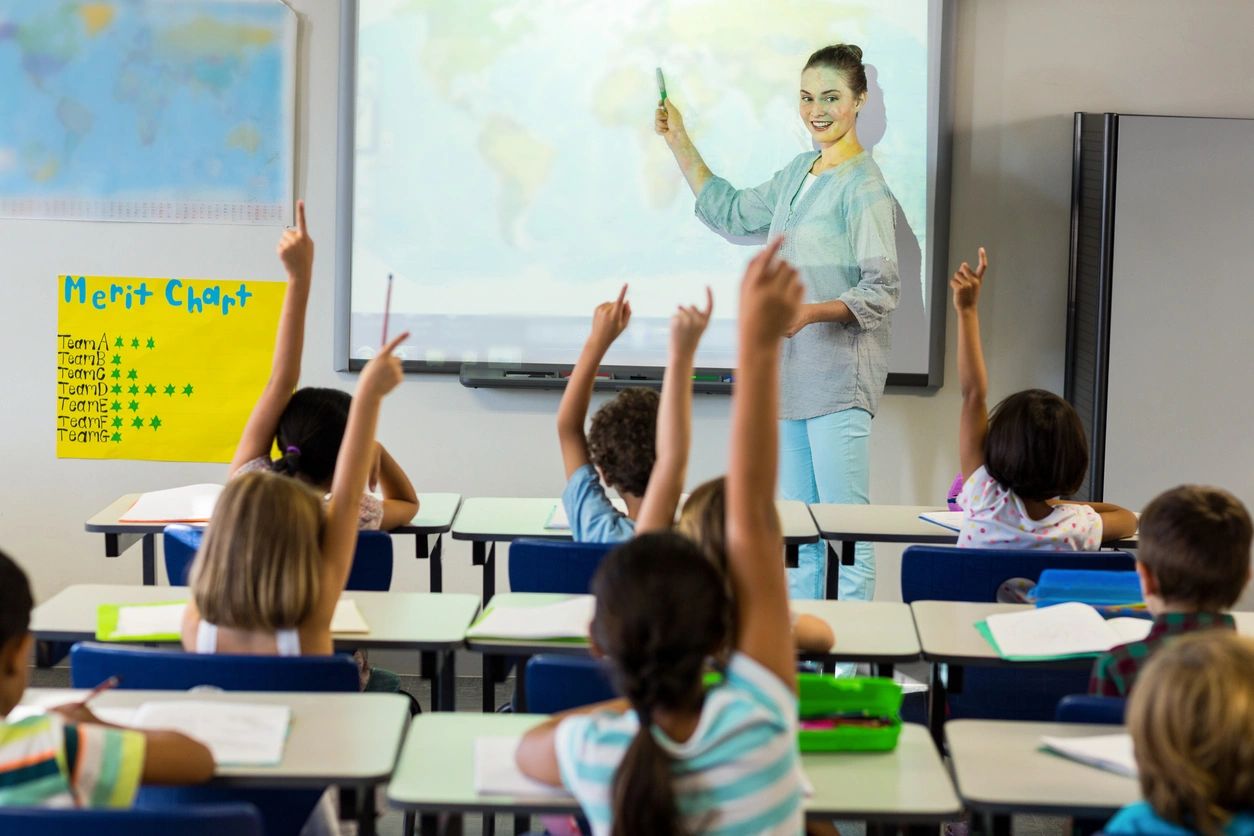 A group of children in front of a class room.